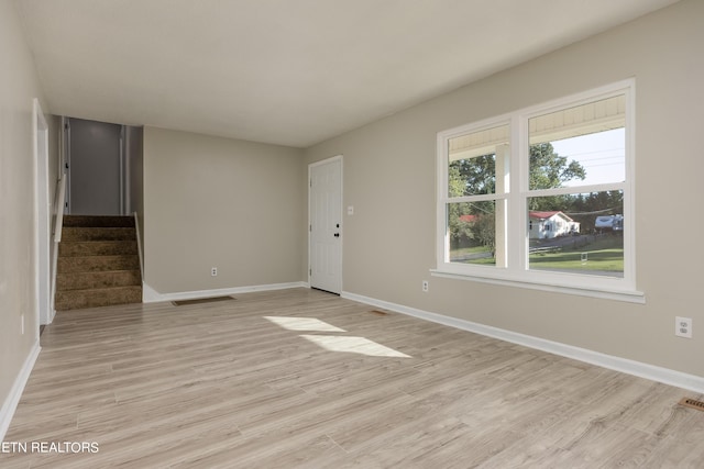 unfurnished room with light hardwood / wood-style floors