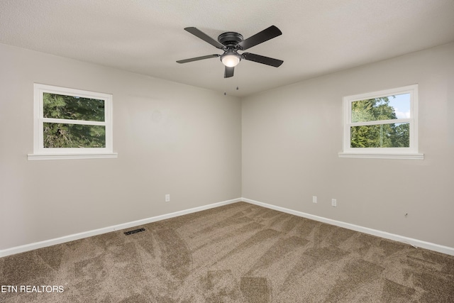 spare room with ceiling fan, carpet floors, and a textured ceiling