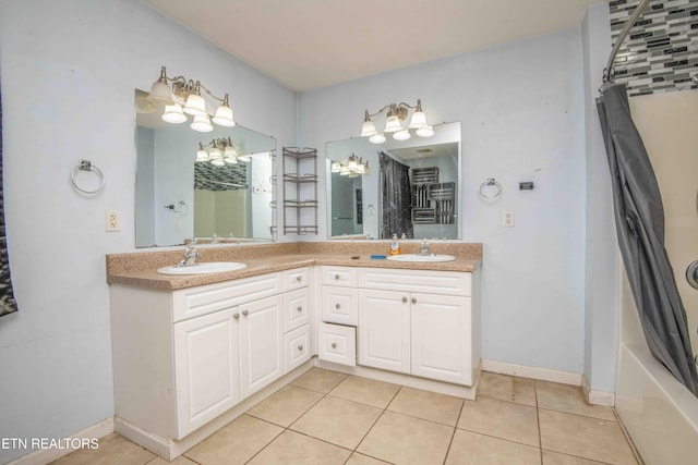 full bath with a shower, tile patterned flooring, a sink, and double vanity