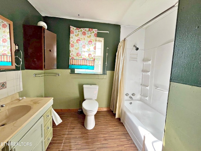 full bathroom with wood-type flooring, shower / bath combination with curtain, vanity, and toilet