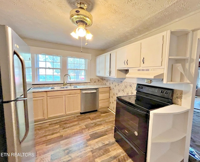 kitchen with ceiling fan, sink, a textured ceiling, light hardwood / wood-style flooring, and stainless steel appliances