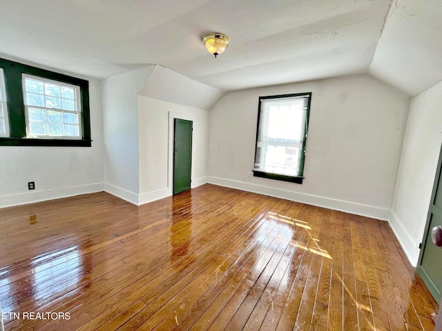 bonus room featuring hardwood / wood-style flooring, vaulted ceiling, and plenty of natural light