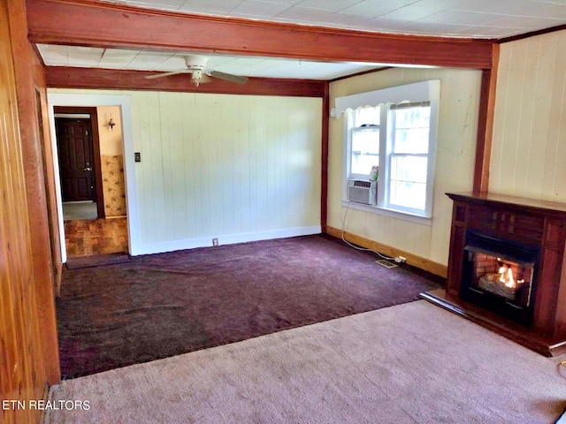 unfurnished living room with carpet, wood walls, ceiling fan, and cooling unit