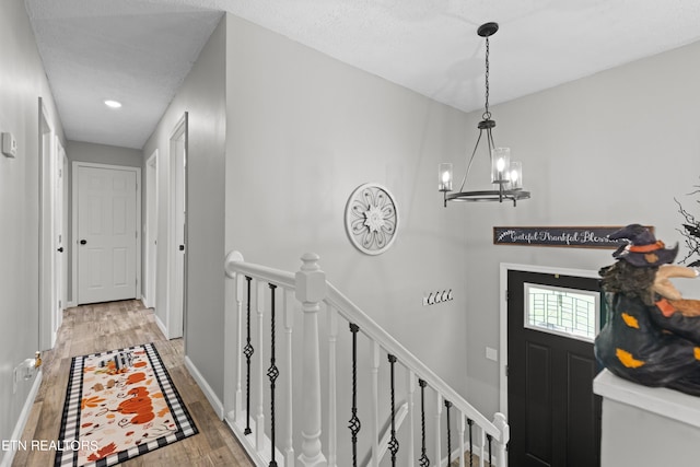 entryway featuring hardwood / wood-style floors and a notable chandelier