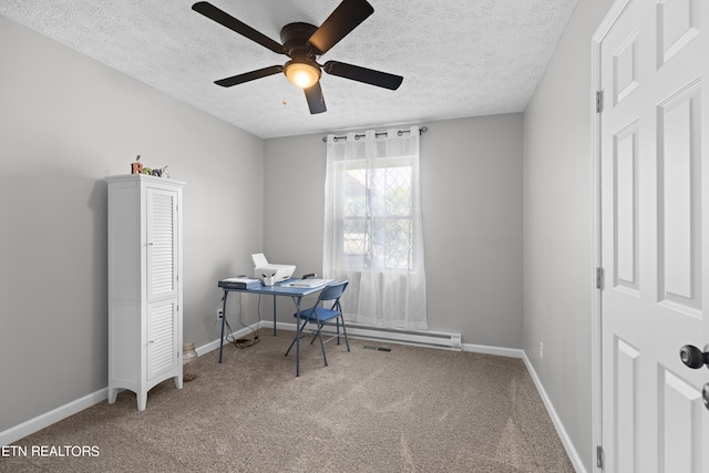 carpeted home office with a textured ceiling and ceiling fan