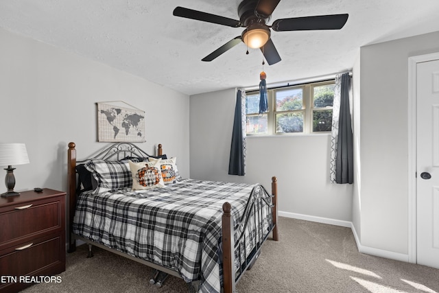 bedroom featuring carpet floors, a textured ceiling, and ceiling fan