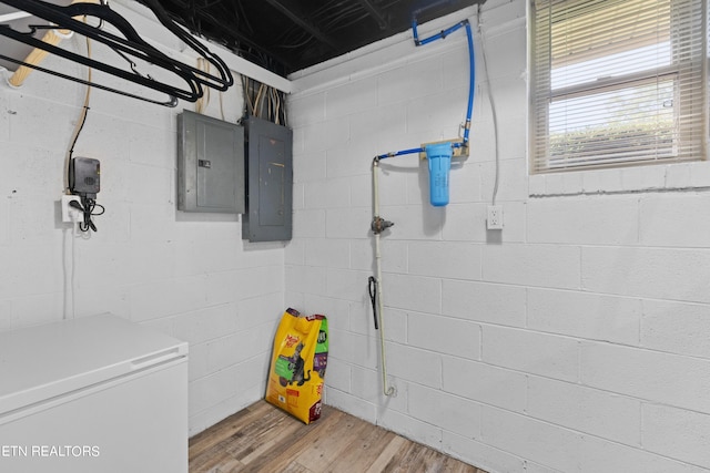 interior space with fridge, hardwood / wood-style flooring, and electric panel