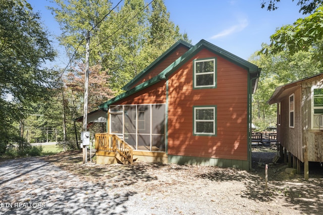 view of home's exterior with a sunroom