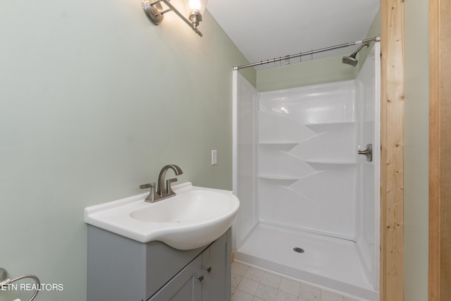 bathroom featuring vanity and a shower