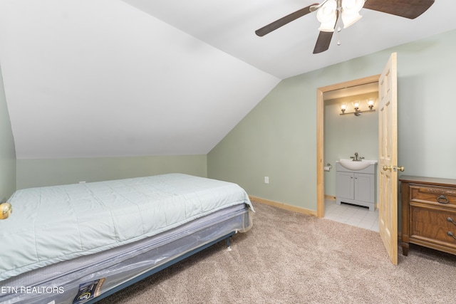 carpeted bedroom featuring ceiling fan, sink, ensuite bathroom, and lofted ceiling