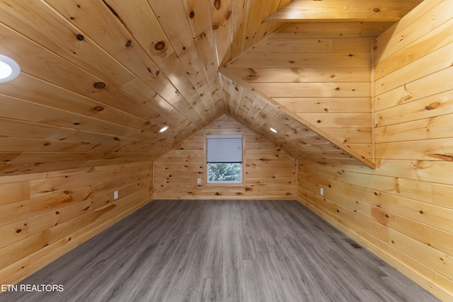 additional living space featuring hardwood / wood-style floors, lofted ceiling, wood walls, and wood ceiling