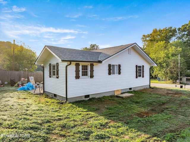 view of side of home with a yard