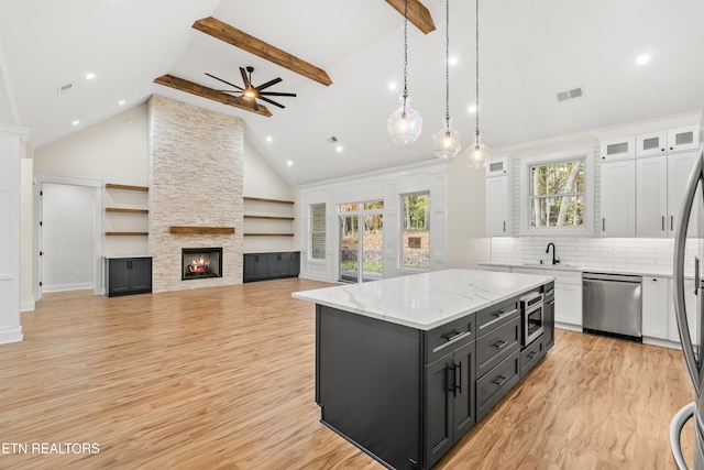 kitchen with visible vents, a sink, white cabinetry, stainless steel appliances, and dark cabinets