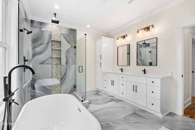 full bathroom with a freestanding tub, marble finish floor, a stall shower, and crown molding