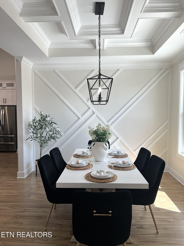 dining space with coffered ceiling, crown molding, and wood finished floors