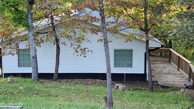 view of side of home featuring a wooden deck