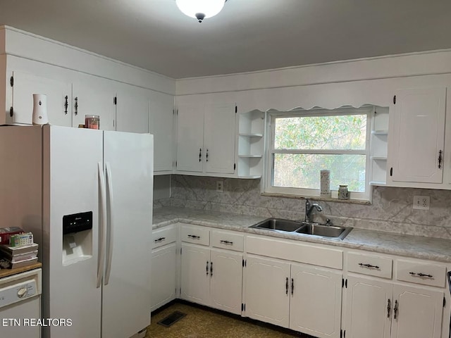 kitchen featuring white appliances, visible vents, light countertops, white cabinetry, and a sink