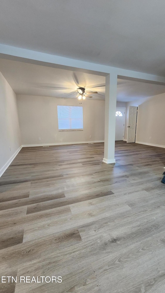 interior space featuring light wood-style flooring and baseboards