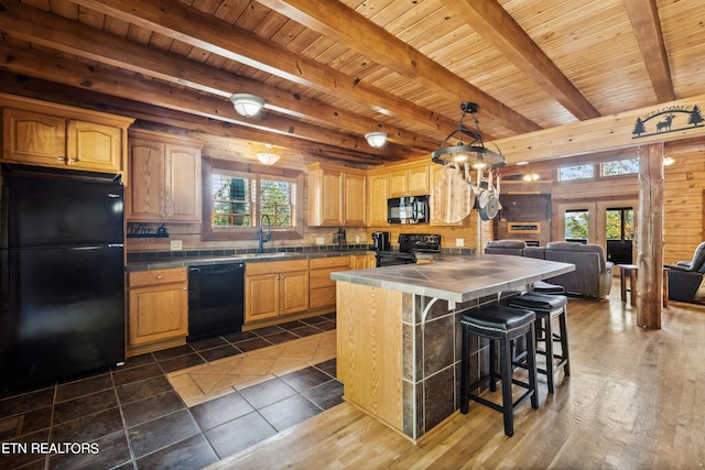 kitchen with beamed ceiling, wood ceiling, sink, black appliances, and dark hardwood / wood-style flooring