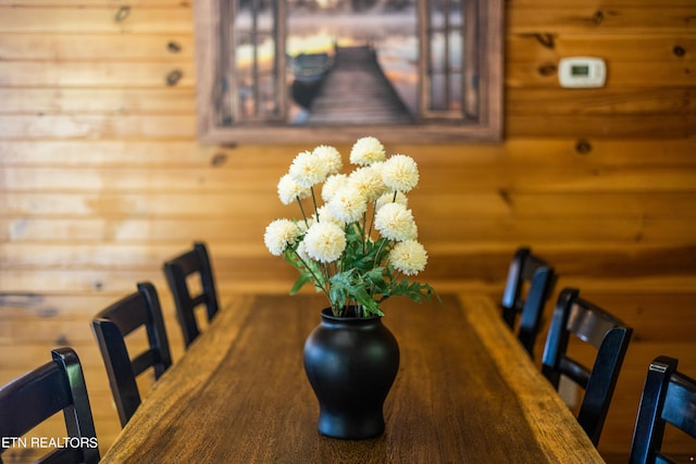 dining space with wood walls