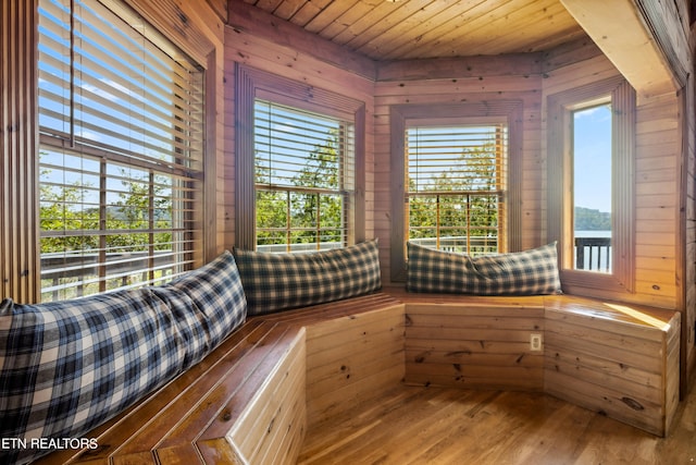 interior space with wood ceiling, wood walls, and hardwood / wood-style floors