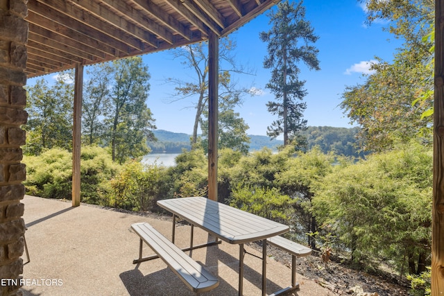 view of patio with a water and mountain view