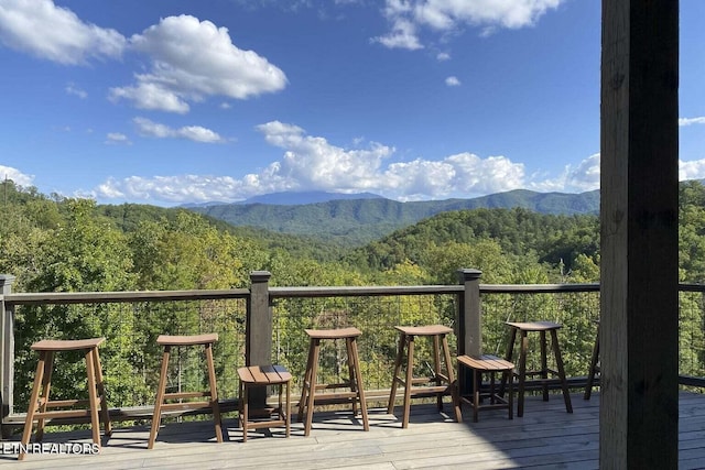 wooden deck with a mountain view