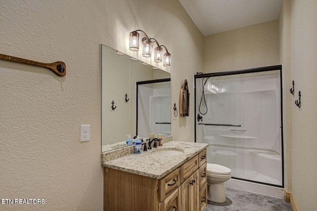 bathroom with walk in shower, vanity, and toilet