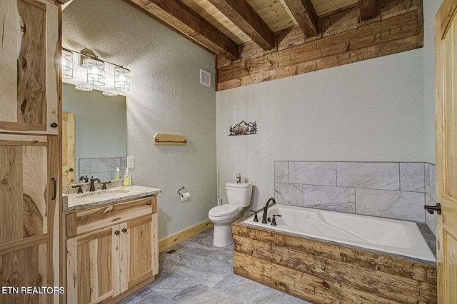 bathroom with vanity, a bathing tub, beam ceiling, and toilet