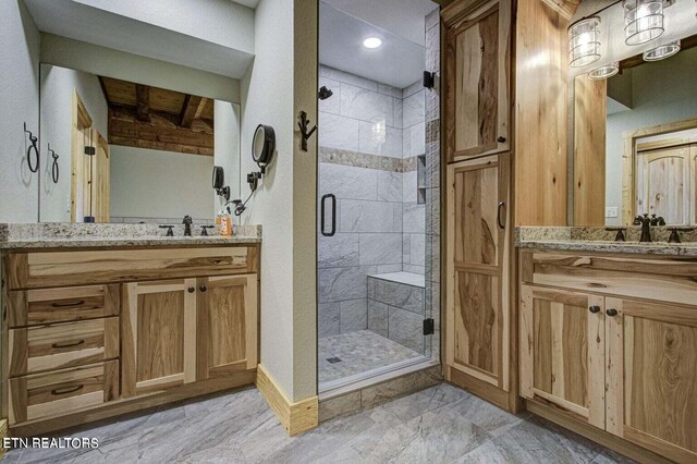 bathroom with vanity and a shower with shower door