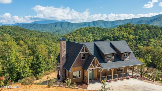 view of front of property with a mountain view and a porch