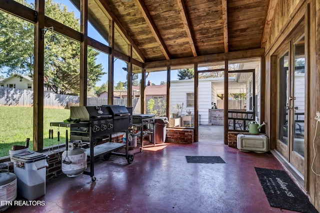 unfurnished sunroom with wood ceiling and lofted ceiling with beams