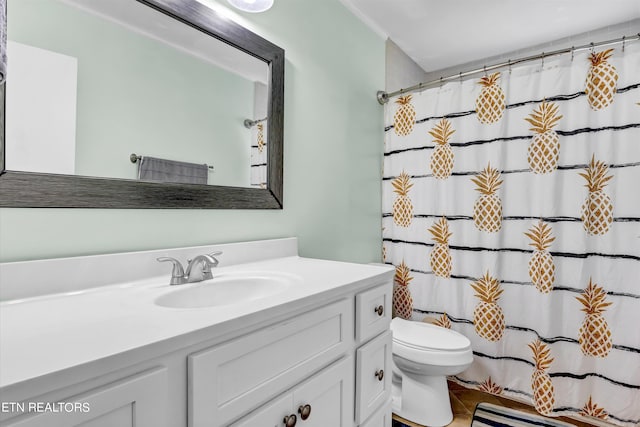 bathroom featuring tile patterned floors, toilet, vanity, and a shower with shower curtain