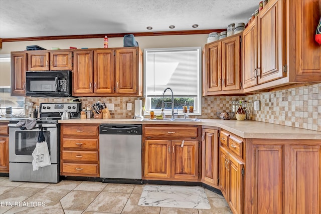 kitchen featuring backsplash, stainless steel appliances, sink, crown molding, and a textured ceiling