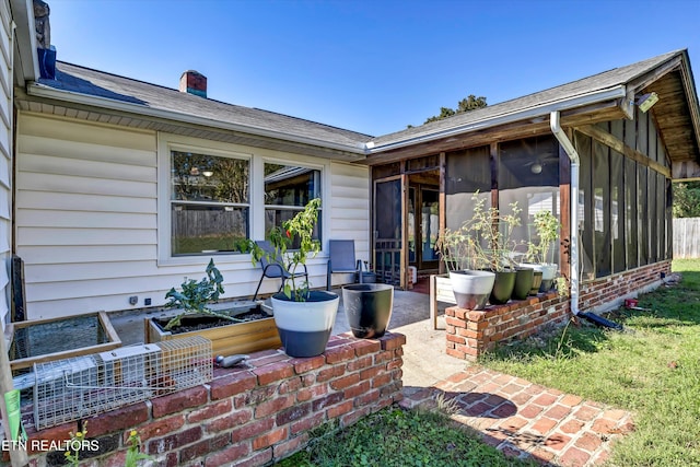 view of patio / terrace featuring a sunroom