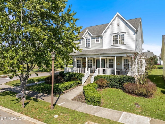 view of front of house featuring a front yard and covered porch