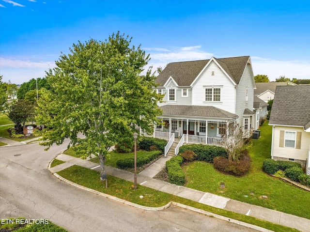 view of front of property featuring a front yard and covered porch