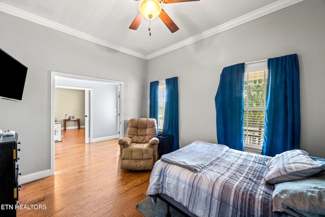 bedroom with ornamental molding, ceiling fan, and hardwood / wood-style flooring