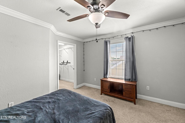 bedroom featuring crown molding, light carpet, and ceiling fan