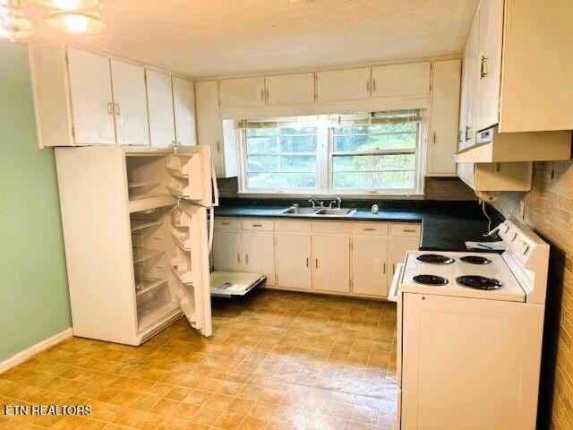 kitchen with decorative backsplash, white cabinetry, sink, and electric range