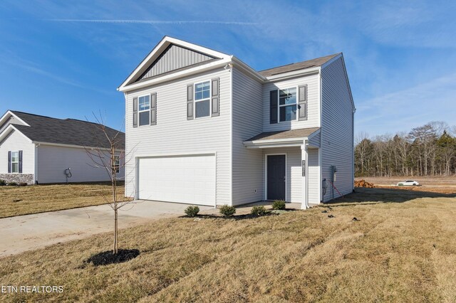 7821 Night Shade Ln, Knoxville, TN 37938 - traditional-style home featuring concrete driveway, an attached garage, a front lawn, and board and batten siding