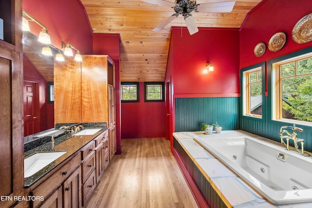 bathroom with wood-type flooring, a bathtub, vaulted ceiling, wooden ceiling, and vanity