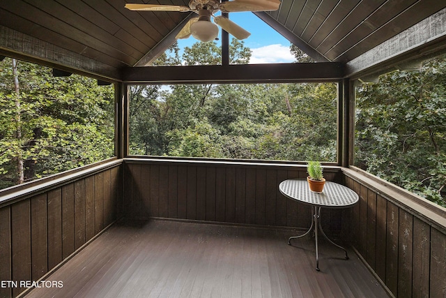 unfurnished sunroom with vaulted ceiling and ceiling fan