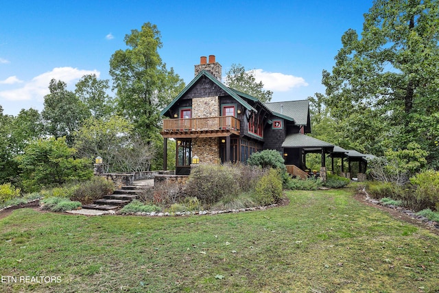 back of property featuring a lawn and a wooden deck