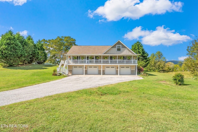 view of front facade with a front yard, a garage, and covered porch