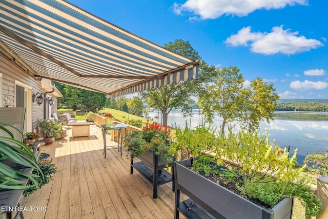 wooden terrace featuring a water view