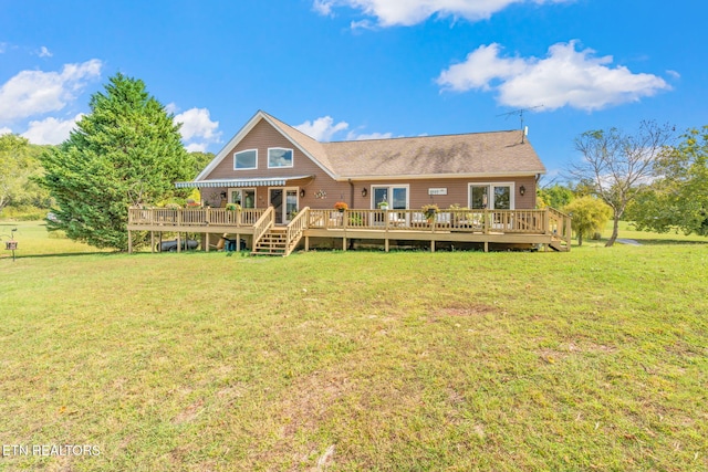 back of house featuring a wooden deck and a lawn