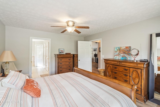 bedroom with light hardwood / wood-style floors, a textured ceiling, and ceiling fan