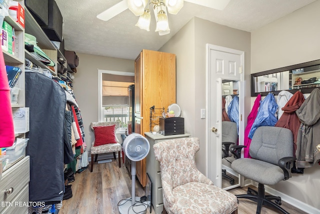 walk in closet with wood-type flooring and ceiling fan