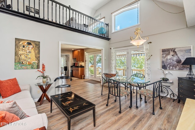 dining area featuring a high ceiling and light hardwood / wood-style floors